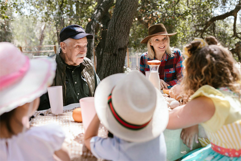 Grandparents eating, sharing and talking with their grandchildren.