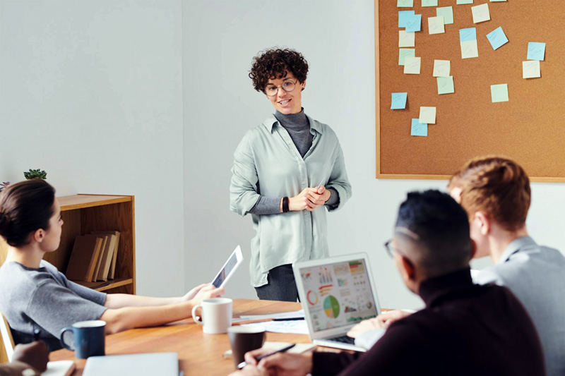 Woman speaking to a group of people.